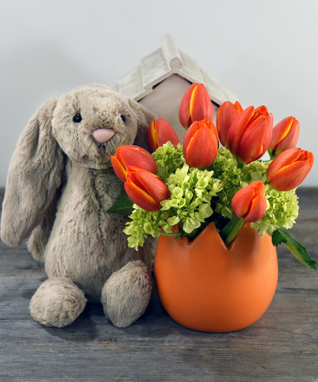 Bright Spring tulips and hydrangea bloom from a ceramic egg container. A cuddly soft plush rabbit. by Jelly Cat complete's your Spring classic look.