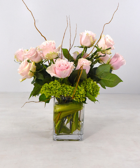 Modern Love is a medley of 12 premium roses with hydrangea and seasonal foliage, designed in a contemporary leaf-lined rectangular glass vase.  