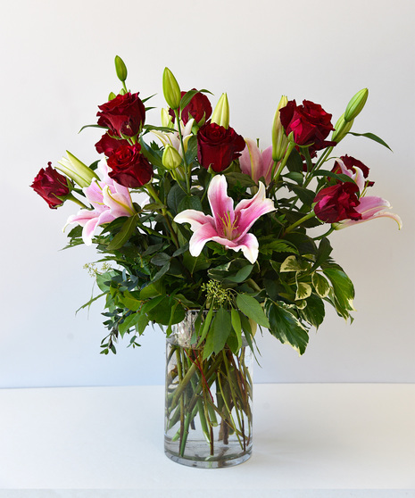 Premium Red Roses with fragrant stargazer liles designed in a clear glass vase.  Upgrade includes hydrangea and snapdragons