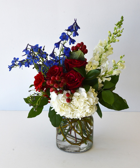 Deluxe variation of Red, White & Blue blooms in a glass vase without the USA flag