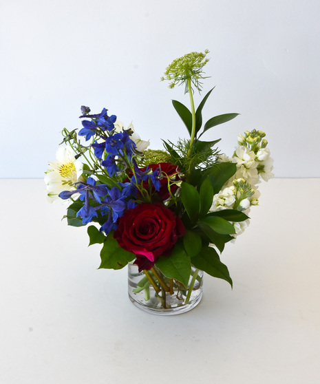 Regular variation of Red, White & Blue blooms in a glass vase without the USA flag